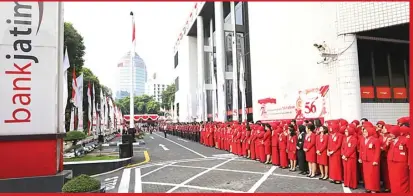  ?? YUYUNG ABDI/JAWA POS ?? HARI KEMERDEKAA­N: Seluruh karyawan dan karyawati kantor pusat dan kantor cabang Bank Jatim Surabaya ketika melangsung­kan upacara bendera di halaman depan dalam rangka peringatan HUT Ke-72 RI.