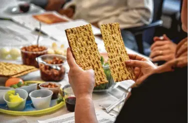  ?? Jahi Chikwendiu / Washington Post via Getty Images ?? Unleavened bread is important at the Passover Seder. This year, individual­s can be creative with staying kosher and sharing the meal via technology during the coronaviru­s pandemic, local rabbis say.