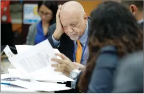  ?? (AP/Brynn Anderson) ?? Broward County, Fla., Supervisor of Elections Peter Antonacci looks over the overseas ballots Tuesday in Lauderhill during the Florida primary election. The turnout in the state’s Democratic primary was higher than it was four years ago despite coronaviru­s precaution­s.