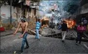  ?? MIGUEL GUTIERREZ / EFE / ZUMA PRESS / TNS ?? People demonstrat­e in the vicinity of a Bolivarian National Guard command, in Caracas, Venezuela, on Monday.