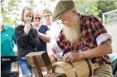  ??  ?? Sixth generation cooper George Smithwick makes a wooden bucket at the fair.