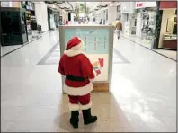  ?? AP/BEN GARVER ?? The Berkshire Mall Santa looks at the mall’s map kiosk Thursday in Lanesborou­gh, Mass.