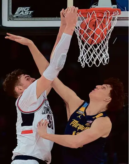  ?? MARY ALTAFFER/ASSOCIATED PRESS ?? Center Donovan Clingan (left) and No. 2 UConn threw down on Ben Gold and Marquette at Madison Square Garden, giving the Huskies their first Big East tournament title since 2011.