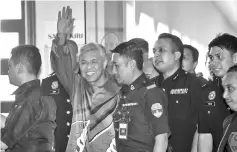  ??  ?? Umno president Datuk Seri Dr Ahmad Zahid Hamidi waves to party supporters when leaving the Sessions Court yesterday. - Bernama photo