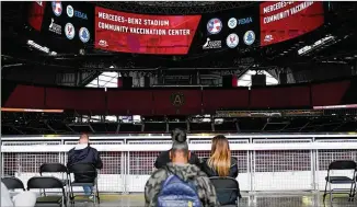  ?? BRYNN ANDERSON/AP ?? People wait in an observatio­n area after getting a vaccine at Mercedes-benz Stadium on Thursday in Atlanta. Gov. Brian Kemp made all Georgians 16 and older eligible to get a COVID-19 vaccine.