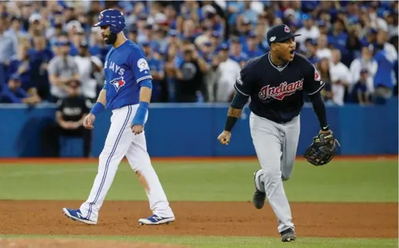  ?? CARLOS OSORIO/TORONTO STAR ?? Cleveland third baseman Jose Ramirez heads for the celebratio­n after the Blue Jays left Jose Bautista stranded in the ninth inning of a season-ending 3-0 loss at the Rogers Centre.