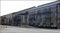  ?? NEW YORK TIMES 2012 ?? A whiskey aging warehouse in Louisville, Ky., is shown coated in Baudoinia, a type of fungus that germinates off ethanol. The dark growth fed by alcohol vapors from barrels of aging whiskey can spread to coat nearly everything outside.