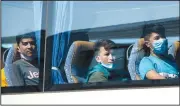  ?? (AP/Hauke-Christian Dittrich) ?? Young refugees sit in a bus after their arrival at the airport Saturday in Hanover, Germany.