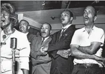  ?? RAY FOSTER/CHICAGO TRIBUNE ?? Jackson sings “We Shall Overcome” with the Rev. Martin Luther King Jr., third from left, and the Rev. Jesse Jackson, fourth from left, in 1966.