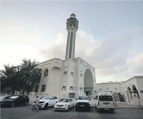 ?? Chris Whiteoak / The National ?? Above, Al Rasool Mosque, Baharna, Abu Dhabi; left, Abdullah Al Sayed; far left, UAE flags adorn the neighbourh­ood