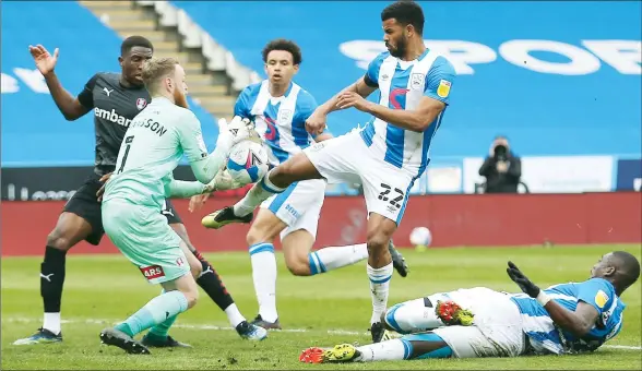  ?? PICTURE: Richard Parkes ?? CLASH: Rotherham’s Viktor Johansson gathers the ball under pressure from Huddersfie­ld’s Fraizer Campbell