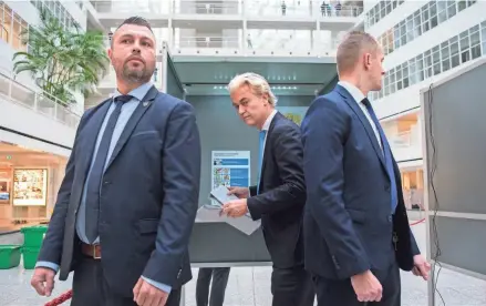  ?? MIKE CORDER/AP FILE ?? Geert Wilders, center, leader of the far-right Party for Freedom, casts his ballot in The Hague, Netherland­s, on Nov. 22. The party received nearly a quarter of all the votes in the election.