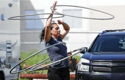  ?? Amanda McCoy / TNS ?? Deya Rosales, a member of Cirque MonteCarlo, practices to pass the time on April 8. The circus should be on the road, but due to the coronaviru­s pandemic, they find themselves sheltering in place on a lot they were able to rent in Grand Prairie.
Exequiel Lopez, who is from Argentina, is one of the many internatio­nal members of Cirque MonteCarlo. He is in the U.S. on a visa that only allows him to perform for employment.