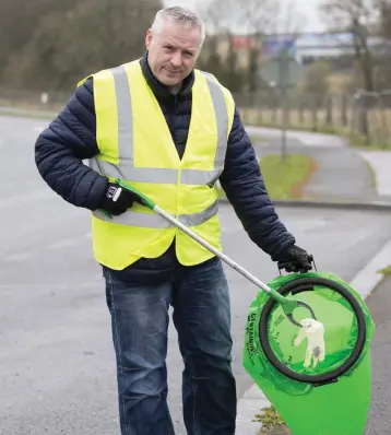  ??  ?? Jason Mulhall of Blessingto­n Tidy Towns picking up discarded gloves.