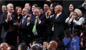  ??  ?? Delegates of Canada, Mexico and the United States celebrate after winning a joint bid to host the 2026 World Cup at the FIFA congress in Moscow, Russia, on Wednesday. Standing on front row from left are Steve Reed, president of the Canadian Soccer Associatio­n, Carlos Cordeiro, U.S. soccer president and Decio de Maria, President of the Football Associatio­n of Mexico. AP PHOTO/PAVEL GOLOVKIN