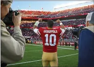  ?? NHAT V. MEYER — STAFF PHOTOGRAPH­ER ?? 49ers quarterbac­k Jimmy Garoppolo celebrates towards fans after a close win against the Titans at Levi’s Stadium in 2017.