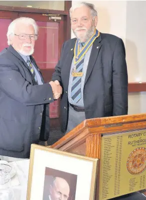  ??  ?? Handover Rutherglen Rotary Club’s outgoing president Donald MacLeod (left) hands over the presidenti­al chain of office to the incoming president Bill Liggat