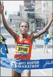  ??  ?? Rita Jeptoo of Kenya reacts as she crosses the final line to win the women’s division of the 2013 Boston Marathon in Boston, April 15. (AP)
