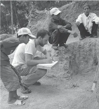  ??  ?? Derek Congram, a Canadian forensic anthropolo­gist, tests soil in Vietnam. He has developed a system that analyzes data to better pinpoint grave sites of people missing in conflict zones.