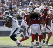  ?? MARCIO JOSE SANCHEZ — THE ASSOCIATED PRESS ?? Los Angeles Rams running back Todd Gurley, left, scores against the Arizona Cardinals during the first half of an NFL football game Sunday in Los Angeles.