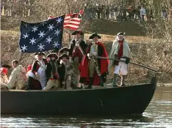  ?? Chris Gardner / AP ?? A re-enactment of George Washington crossing the Delaware.