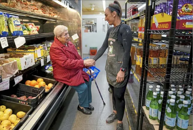  ?? ?? “I come here every day,” says Linda Ficorilli, 80, as she chats with Sandy Falcione, who has worked at Donatelli’s Italian Food Center in Bloomfield for 28 years. “I miss it already.”