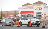  ?? JANE TYSKA /ASSOCIATED PRESS ?? Customers line up at the In-N-Out drive-thru off Hegenberge­r Road in Oakland, Calif., on Monday. In-N-Out will close its only restaurant in Oakland because of a wave of car break-ins, property damage, theft and armed robberies targeting customers and employees alike, the company announced.