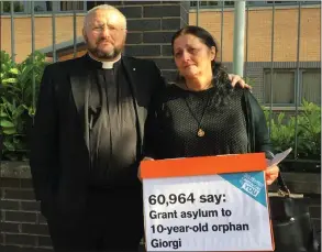  ??  ?? Reverend Brian Casey and Giorgi’s gran Ketino Baikhadze with the petition in Glasgow