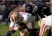  ?? DAVID BANKS — THE ASSOCIATED PRESS ?? San Francisco 49ers quarterbac­k Jimmy Garoppolo (10) dives into the end zone past Chicago Bears linebacker Trevis Gipson for a touchdown during the second half Sunday in Chicago.