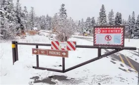  ?? GREG SORBER/JOURNAL ?? ABOVE: The Capulin Snow Play Area in the Sandia Mountains, which underwent a million-dollar renovation in 2010, remained closed last week, according to signs posted at the entry gate off state Highway 536.