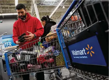  ?? Eduardo Munoz Alvarez/Associated Press ?? Francisco Santana shops at the Walmart Supercente­r in North Bergen, N.J., on Feb. 9. The inflation surge led Santana, a New York City resident, to shift his grocery shopping from local chains to Walmart.