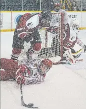  ?? BOB TYMCZYSZYN THE ST. CATHARINES STANDARD ?? Thorold’s Brennan Ireland reached over St. Catharines’ Christian Girhiny for a loose puck in Greater Ontario Junior Hockey League action Friday night at Jack Gatecliff Arena in St. Catharines.