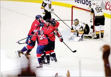  ?? AP PHOTO BY PABLO MARTINEZ MONSIVAIS ?? Teammates celebrate with Washington Capitals forward T.J. Oshie, center of the huddle, who scored a goal past Vegas Golden Knights goaltender Marc-andre Fleury (29) during the first period in Game 4 of the NHL hockey Stanley Cup Final, Monday, June 4...