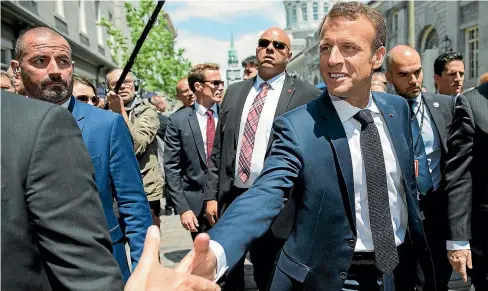  ?? AP ?? French President Emmanuel Macron greets a well-wisher during a tour of Old Montreal yesterday.