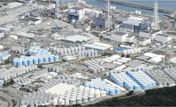  ?? DAISUKE SUZUKI/KYODO NEWS VIA THE ASSOCIATED PRESS ?? Hundreds of tanks full of radioactiv­e water surround the Fukushima Dai-ichi nuclear plant in Okuma, Japan.