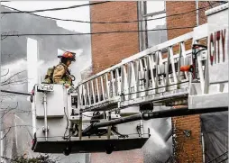  ?? JOHN SPINK/JOHN.SPINK@AJC.COM ?? Firefighte­rs battle a large blaze Thursday morning at the former Morris Brown College dormitory on Martin Luther King Jr. Drive in Atlanta. It was returned to Clark Atlanta University after a 2017 court ruling.