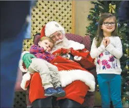  ??  ?? Tom Myers poses with Wyatt Padden, 2, and Claire Padden, 5. His beard is real, and he gets it bleached and curled at a salon every two weeks.