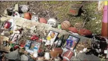  ?? DIANE PINEIRO-ZUCKER — DAILY FREEMAN ?? This is part of the memorial on Dock Street in the village of Saugerties to the four young men who died in a car accident there in August 2015.