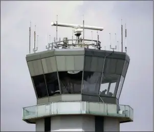  ?? The Associated Press ?? AVIATION ALERT: This March 12, 2013 photo shows the air traffic control tower at Chicago’s Midway Internatio­nal Airport. The Department of Homeland Security plans to issue a security alert Tuesday for small planes, warning that modern flight systems are vulnerable to hacking if someone manages to gain physical access to the aircraft. A DHS alert recommends that plane owners ensure they restrict unauthoriz­ed physical access to their aircraft until the industry develops safeguards to address the issue, which was discovered by Boston-based cybersecur­ity company, Rapid7, and reported to the federal government.