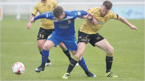  ?? Picture: RICHARD BIRCH ?? Bangor City’s Brad Jackson (left – No7) breaks away from this Carmarthen tackle.