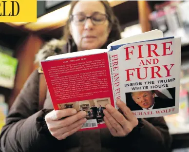  ?? CHARLES REX ARBOGAST / THE ASSOCIATED PRESS ?? Kathy Mallin, from Glenview, Ill., looks over a copy of the book Fire and Fury: Inside the Trump White House by Michael Wolff at Chicago’s Barbara’s Bookstore on Friday, the day that it went on sale.