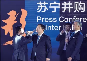  ??  ?? Inter Milan Chairman Erick Thohir (left) and Suning Group Chairman Zhang Jindong (second left), raise a toast at a news conference in Nanjing, capital of east China’s Jiangsu Province, on June 6, 2016, after China’s retail giant Suning Group announced...