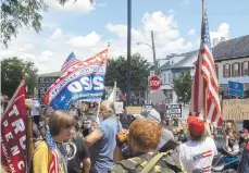  ??  ?? At least 200 people filled the Triangle, the pro-Trump crowd double the size of the Black Lives Matter group.