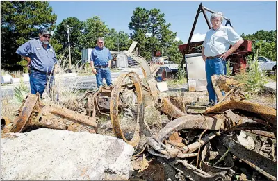  ?? NWA Democrat-Gazette/DAVID GOTTSCHALK ?? Rob Mullins (from left), public works manager for Eureka Springs, public works Director Dwayne Allen and Mayor Robert “Butch” Berry stand amid the rusted remnants of cars dug up from beneath a street.