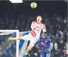  ?? — AFP photo ?? Napoli’s defender Min-jae Kim (top) and Cremonese’s forward Felix AfenaGyan go for a header during the Italian Serie A football match at the DiegoMarad­ona stadium in Naples.