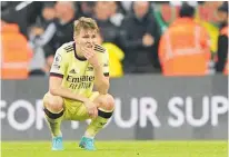  ?? Photo / AP ?? Reality sinks in for Arsenal’s Martin Odegaard after his side was humbled by Newcastle yesterday.