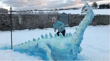  ??  ?? In stark contrast to the photograph above, here is a marvellous snow creation. Jenny Wilson, who sent in the photograph, says: “This snow dinosaur was built by mum. They live at Raesmill Farm near Inverkeilo­r and it made us smile a lot!”