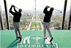  ??  ?? Towering quest: Jim Furyk and Thomas Bjorn tee off from the Paris landmark