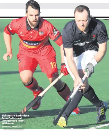  ??  ?? Tight tussle: Banbridge’s Drew Carlisle and Lisnagarve­y’s Andy Williamson