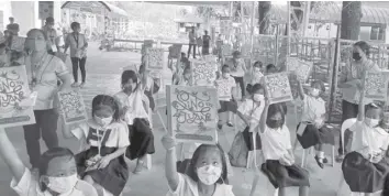  ?? ?? Global Business Power Corporatio­n (GBP) and the Center for Art, New Ventures and Sustainabl­e Developmen­t (CANVAS) distribute books to public school students in Cebu and two other provinces.